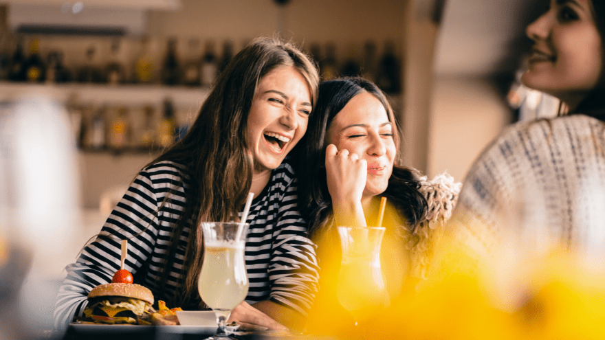 Happy friends dining at restaurant